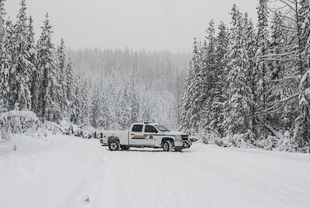 Police check out the blocked road leading to the Gidimt'en checkpoint near Houston B.C., on Thurs. Jan. 9, 2020. Mounties in northern B.C. say they are enforcing an injunction preventing protests from blockading an access road for about 500 people working on the Coastal GasLink natural gas pipeline. THE CANADIAN PRESS/Jason Franson.