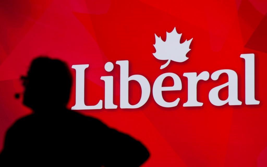 A Liberal Party of Canada logo is shown on a giant screen as a technician looks on during day one of the party's biennial convention in Montreal, Thusday, February 20, 2014. THE CANADIAN PRESS/Graham Hughes.