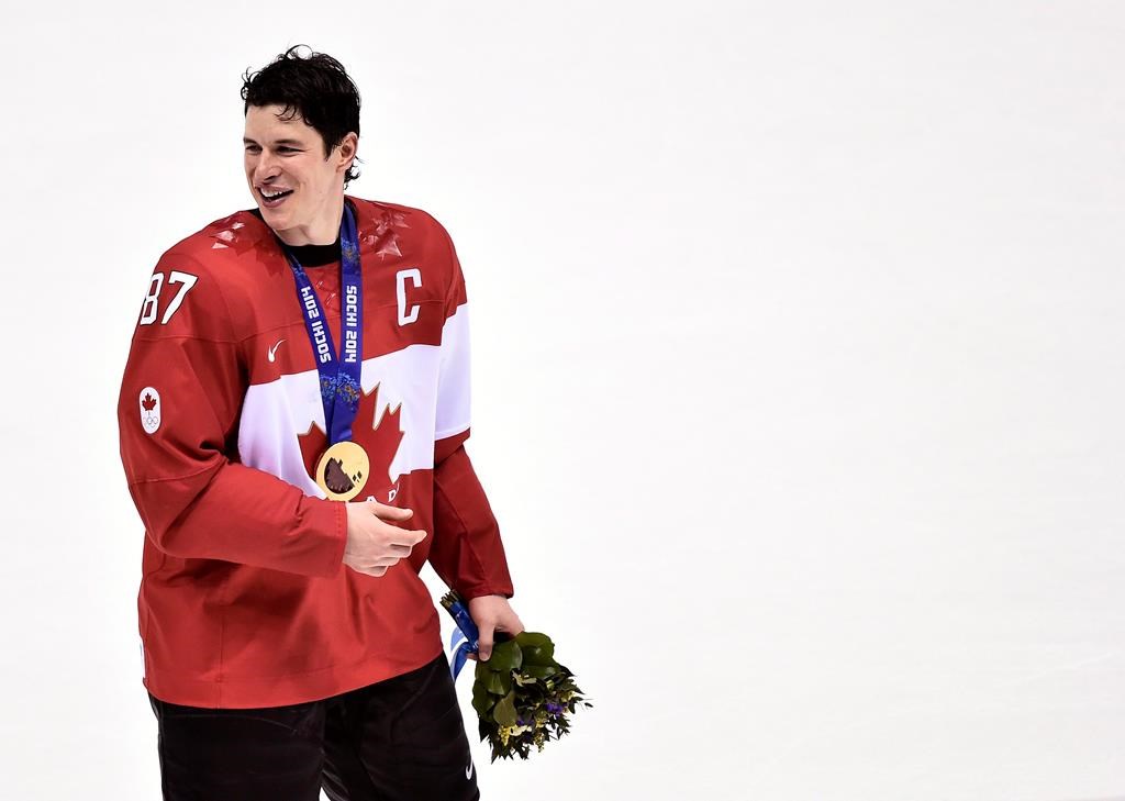 Canada captain Sidney Crosby smiles with his gold medal after Canada defeated Sweden during third period finals hockey action at the 2014 Sochi Winter Olympics in Sochi, Russia on February 23, 2014. THE CANADIAN PRESS/Nathan Denette