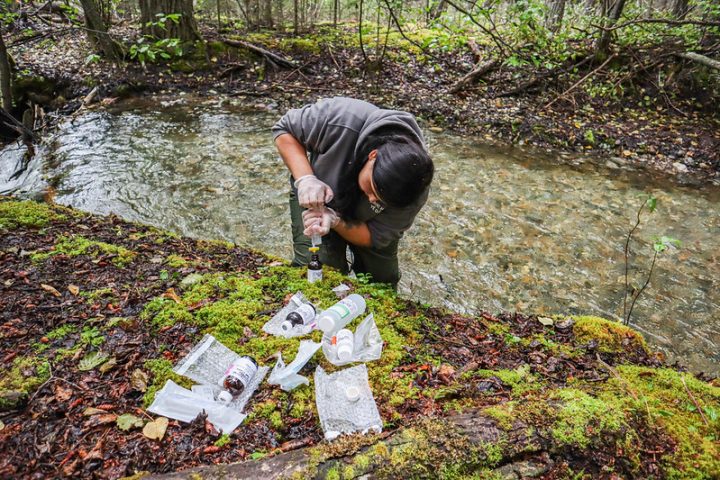 Member of the Dane Nan Yḗ Dāh Guardians tests water quality for the Kaska Dena Council in northern BC.