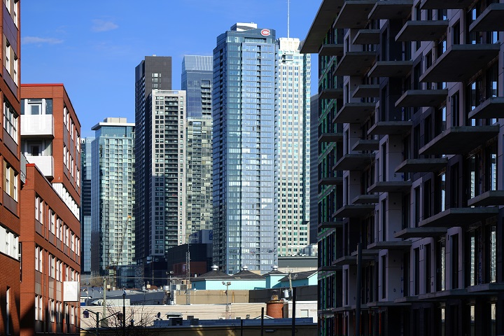 View of downtown Montreal viewed from between new housing projects in Griffintown in Montreal, Que., Tuesday, March 30, 2021.