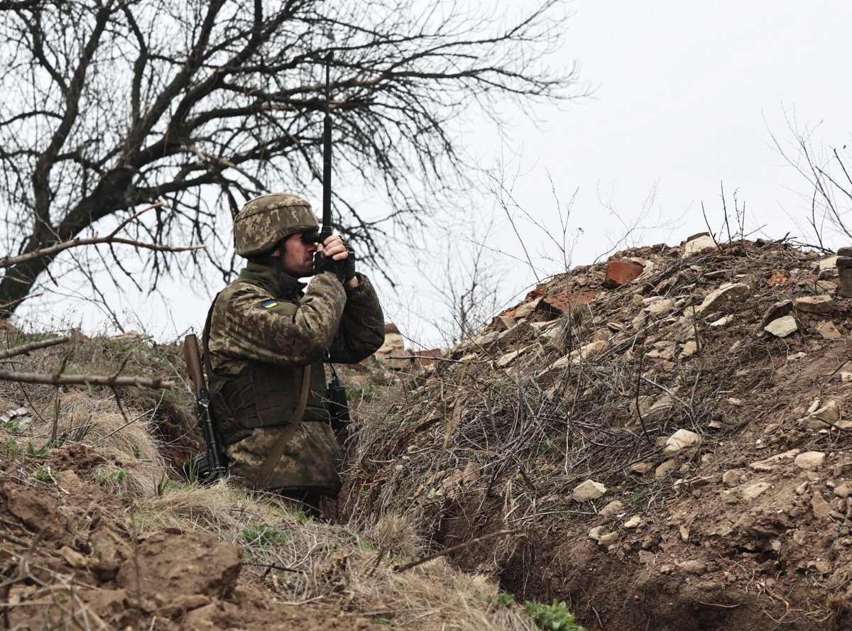 A Ukrainian soldier is seen at fighting positions on the line of separation from pro-Russian rebels near Donetsk, Ukraine, Monday, April 12, 2021.