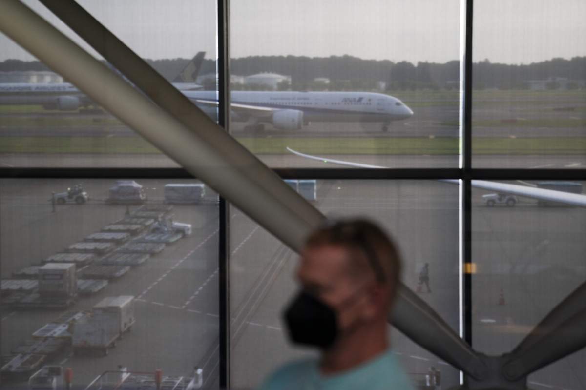 A foreign visitor waits in the holding area to take a COVID-19 test at the Narita International Airport on July 10, 2021, in Narita, near Tokyo. Japan’s massive security apparatus for the upcoming Summer Olympics is raising complaints that the nation, during the weeks of the Games, will look more like authoritarian North Korea or China than one of the world’s most powerful, vibrant democracies. (AP Photo/Jae C. Hong).