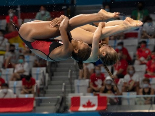 Canadian divers Jennifer Abel (left) and Melissa Citrini-Beaulieu perform a dive on their way to winning the silver in the women’s three-metre synchronized springboard diving during the Tokyo Olympics in Tokyo, Japan on Sunday, July 25, 2020.