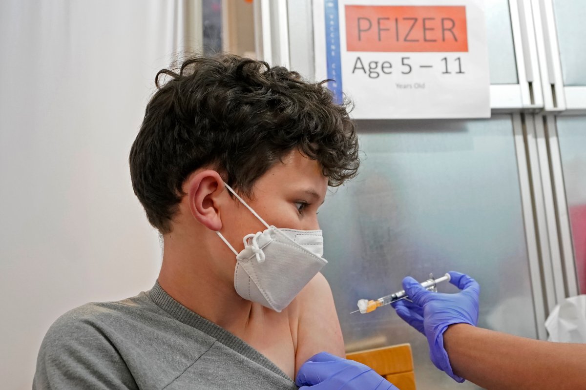 Leo Hahn, 11, gets the first shot of the Pfizer COVID-19 vaccine, Tuesday, Nov. 9, 2021, at the University of Washington Medical Center in Seattle.