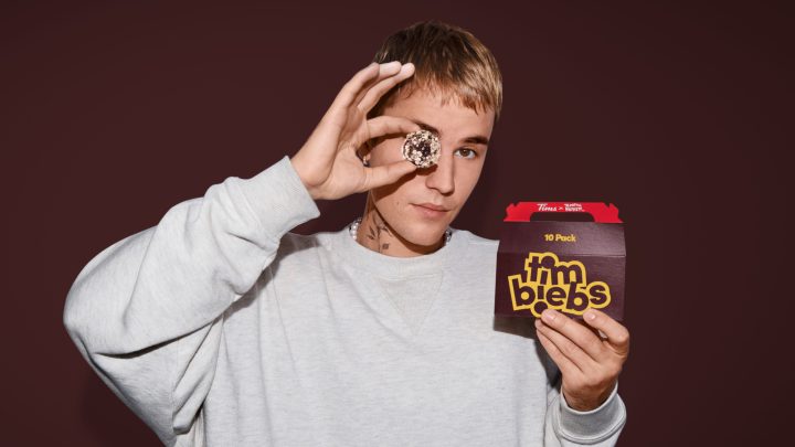 Justin Bieber holds a pack of Tim Hortons' new Timbit flavours, called Timbiebs in this undated handout photo. Tim Hortons has teamed up with pop superstar Justin Bieber to launch three new Timbit flavours —called Timbiebs — along with co-branded merchandise.
