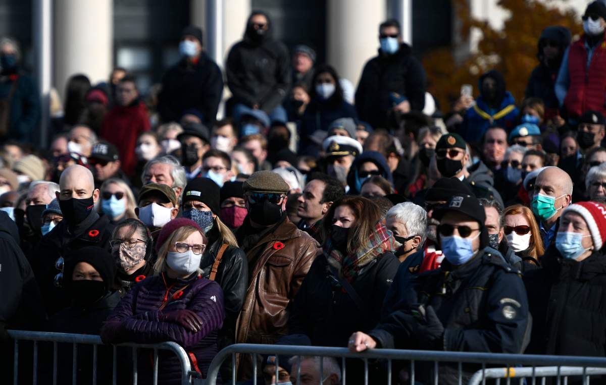 People line Elgin Street during the National Remembrance Day Ceremony at the National War Memorial in Ottawa, on Thursday, Nov. 11, 2021.