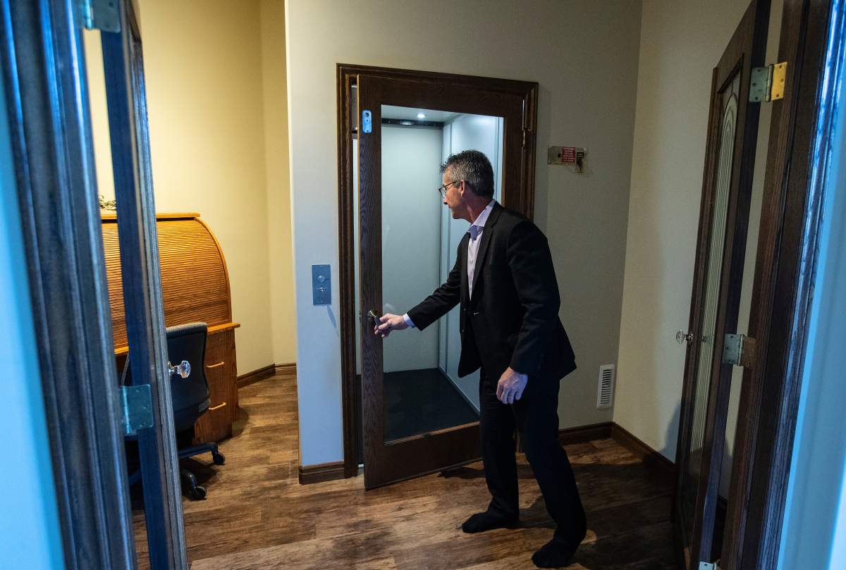 Real estate agent, Brian Cyr opens an elevator to the basement of what is considered the gold standard of homes for people with disabilities, in St. Albert, Alta., on Thursday November 4, 2021.