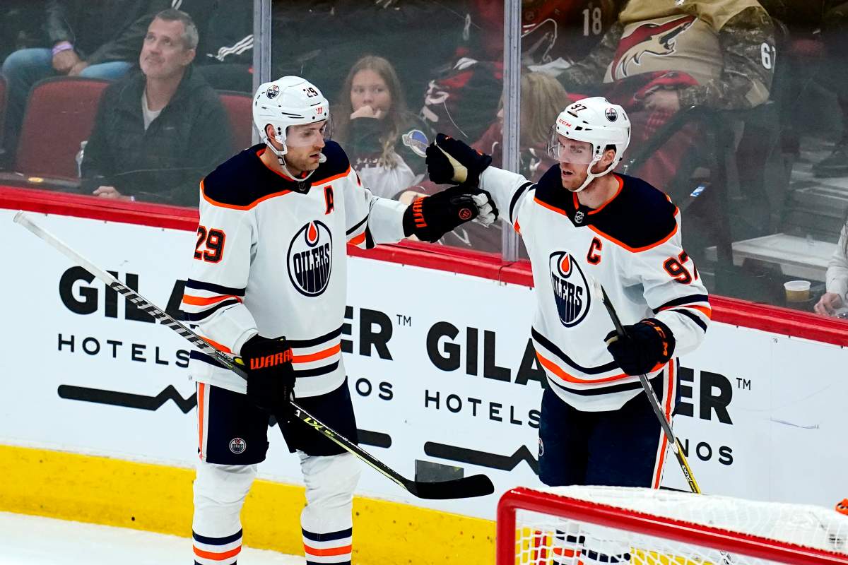 Edmonton Oilers center Leon Draisaitl (29) celebrates his goal against the Arizona Coyotes with Oilers center Connor McDavid (97) during the second period of an NHL hockey game Wednesday, Nov. 24, 2021, in Glendale, Ariz.