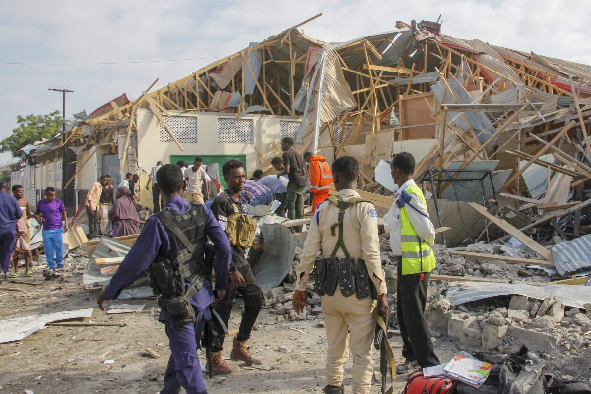 Security forces and rescue workers search for bodies at the scene of a blast in Mogadishu, Somalia Thursday, Nov. 25, 2021. Witnesses say a large explosion has occurred in a busy part of Somalia's capital during the morning rush hour. (AP Photo/Farah Abdi Warsameh).