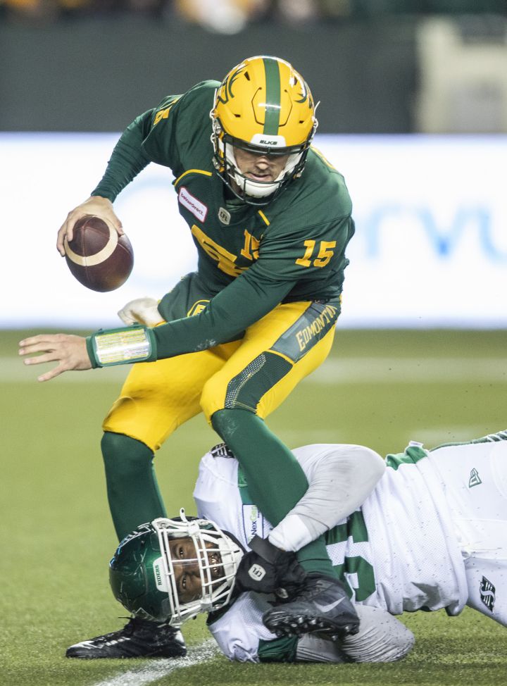 Saskatchewan Roughriders’ Anthony Lanier II (91) catches up to Edmonton Elks quarterback Taylor Cornelius (15) during first half CFL action in Edmonton on Friday, November 5, 2021.