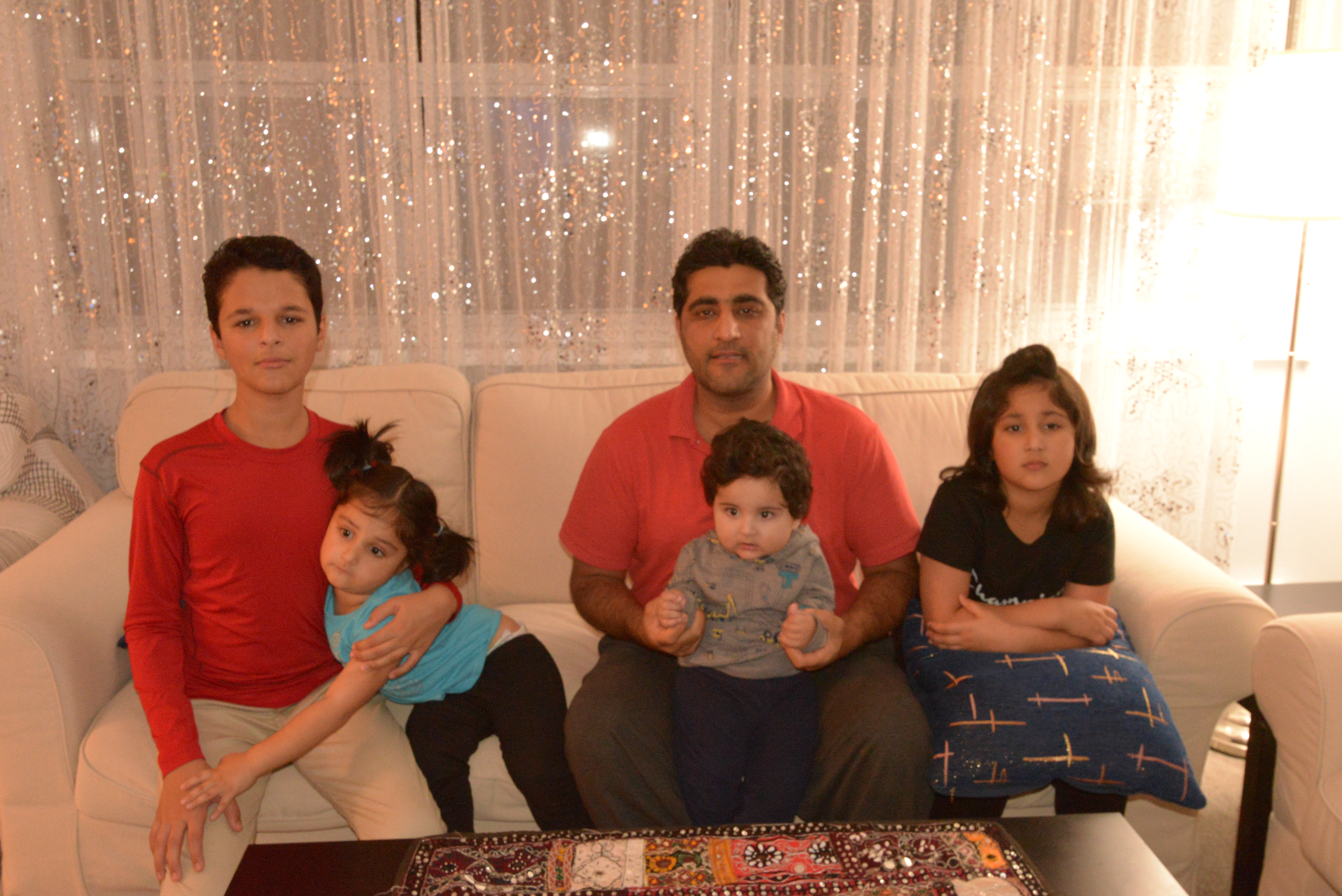 Former Canadian military interpreter Wahdat Weish and his children at their home in Toronto.