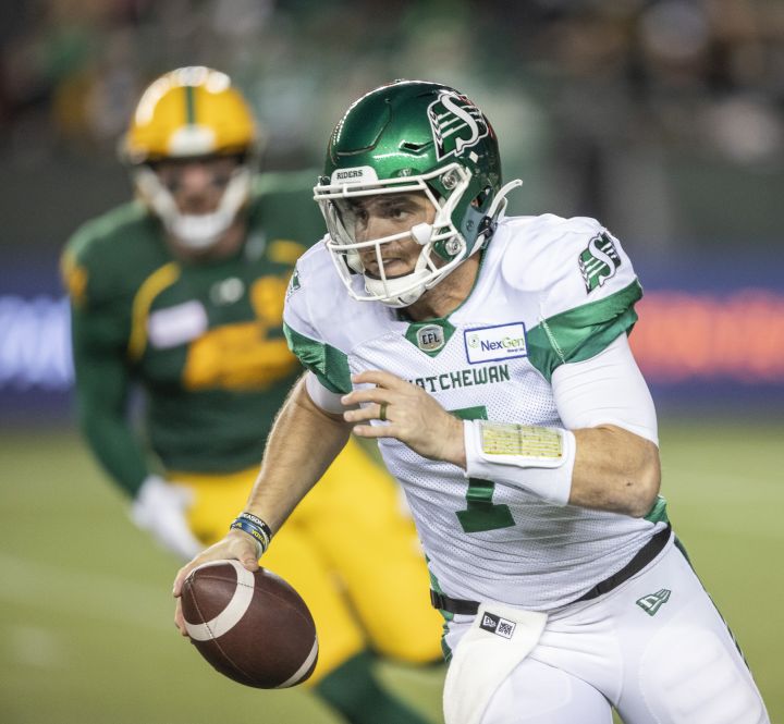 Saskatchewan Roughriders quarterback Cody Fajardo (7) runs the ball under pressure from Edmonton Elks’ Chris Nelson (92) during first half CFL action in Edmonton on Friday, November 5, 2021.