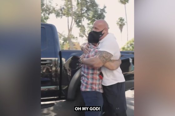 Dwayne Johnson is seen embracing a veteran after giving him his own personal truck