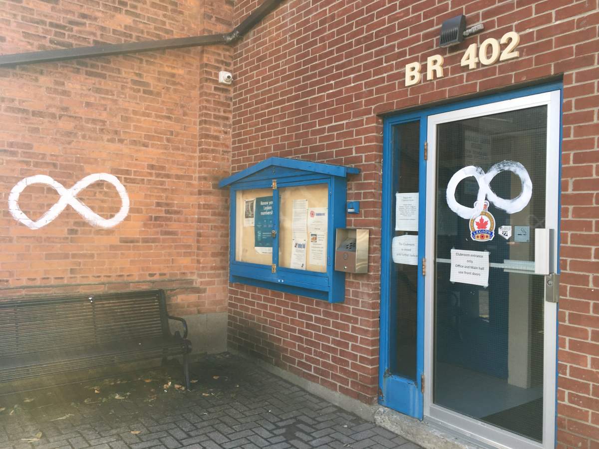 White symbols painted on the Royal Canadian Legion Branch 402 building in Millbrook.