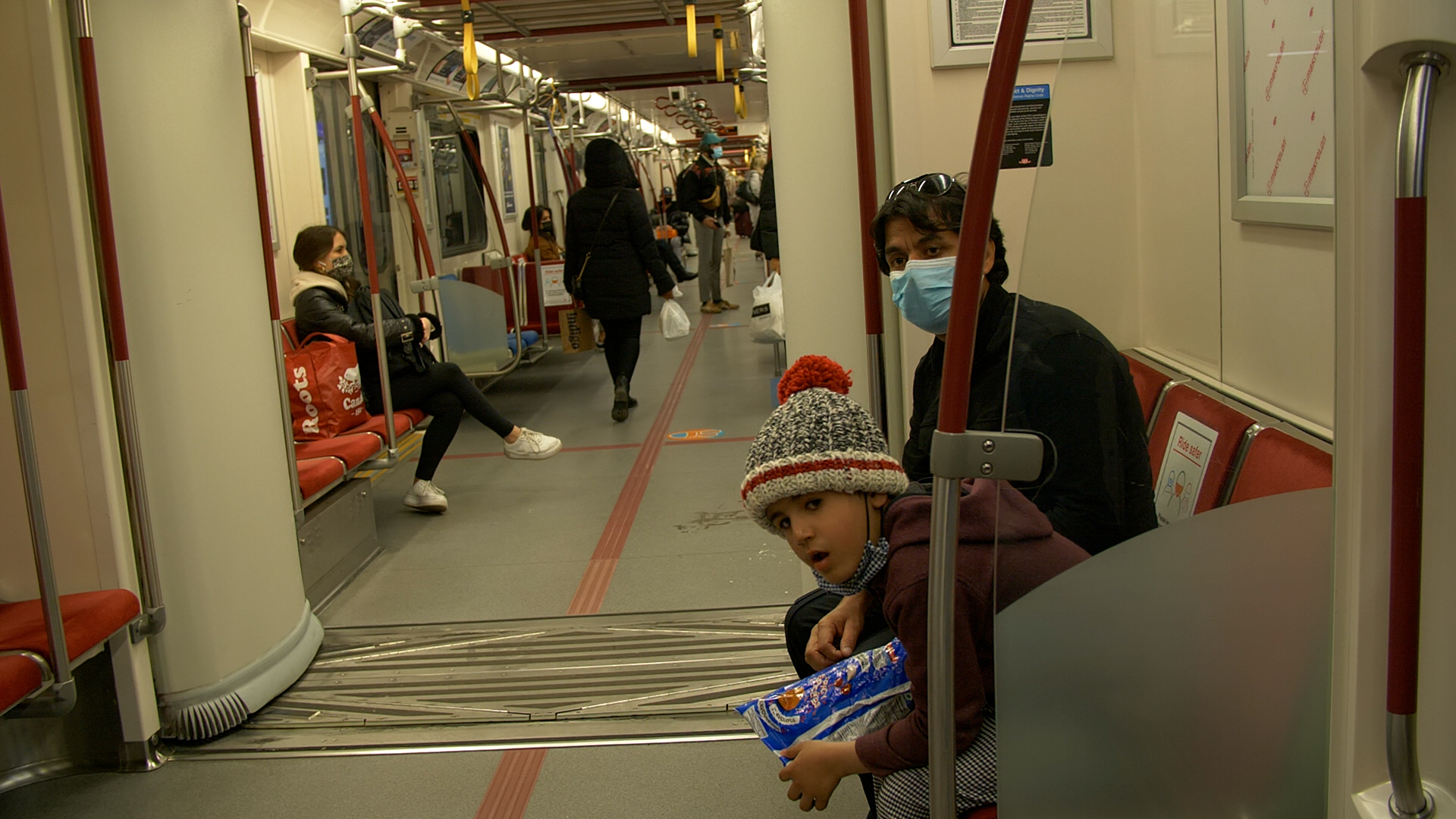 Mohammad Ismail and his son take their first subway ride after arriving as refugees in Toronto.