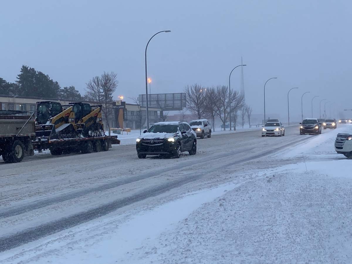 Traffic driving on Gateway Boulevard during a heavy snowfall in Edmonton, Alta. on Tuesday, Nov. 16, 2021.