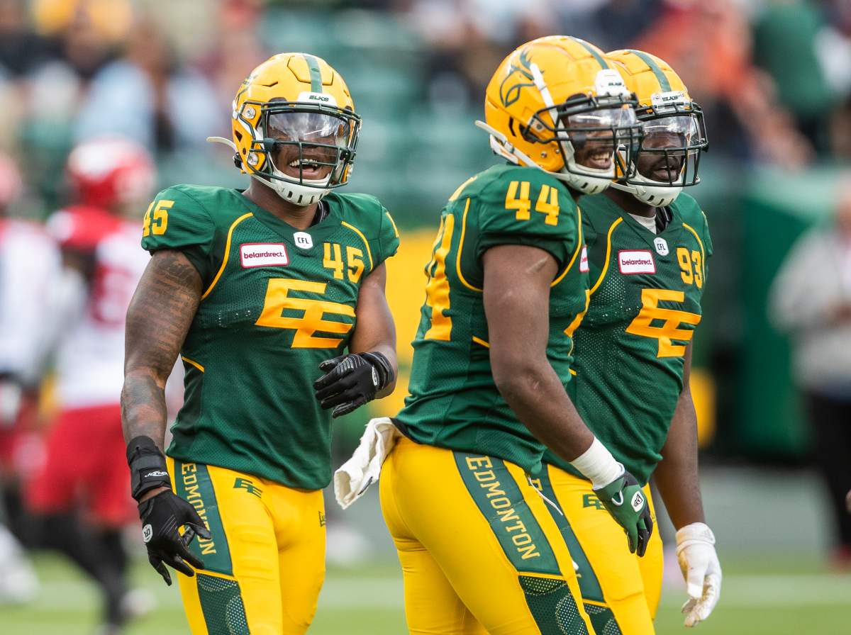 Edmonton Elks’ Nyles Morgan (45), Keishawn Bierria (44) and Kwaku Boateng (93) celebrate a tackle on Calgary Stampeders quarterback Bo Levi Mitchell (19) during first half CFL action in Edmonton, Alta., on Saturday September 11, 2021.
