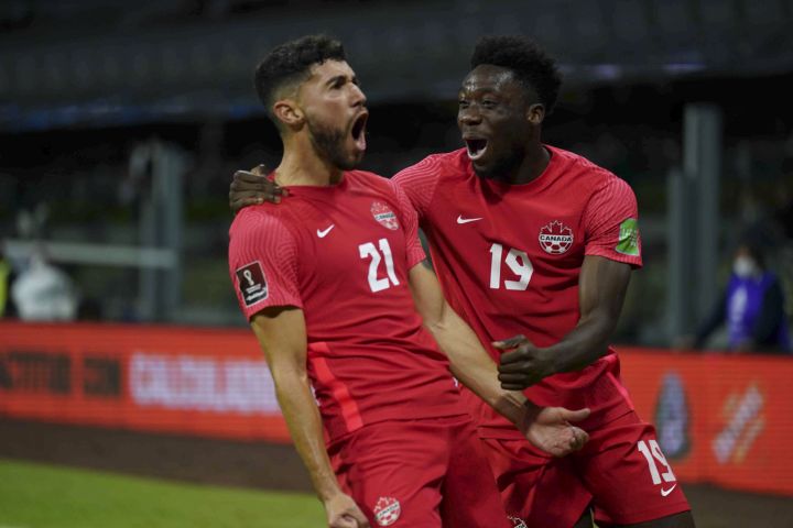 Canada's Jonathan Osorio, left, celebrates scoring his side's first goal against Mexico during a qualifying soccer match for the FIFA World Cup Qatar 2022, at Azteca stadium in Mexico City, Thursday, Oct. 7, 2021. 