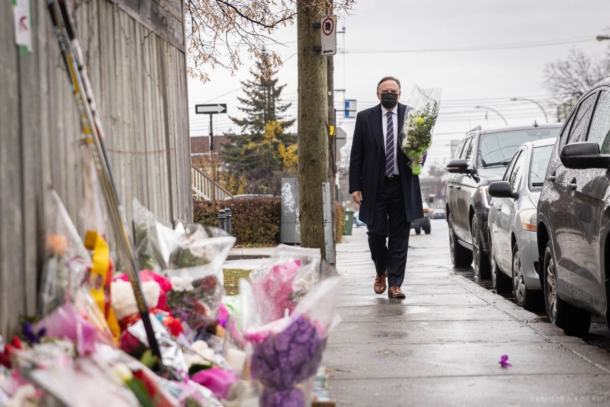 Quebec Premier François Legault lays flowers at Thomas Trudel's impromptu memorial in the Saint-Michel district, where he was shot and killed.