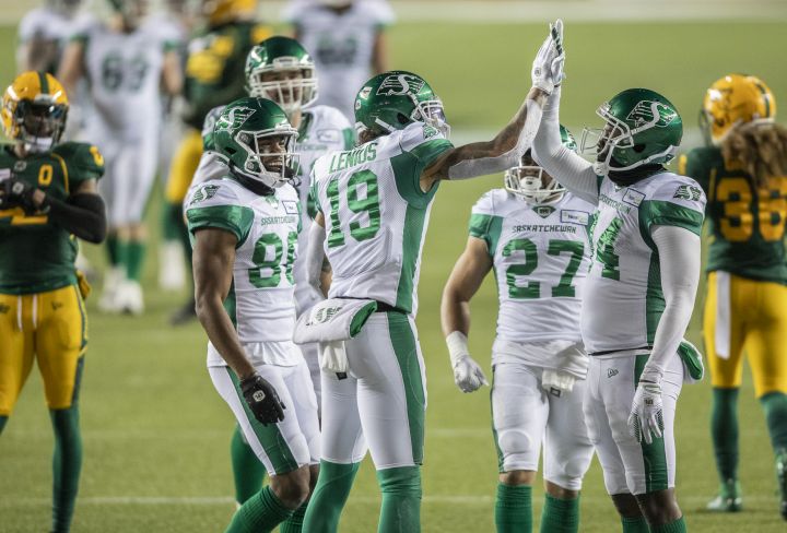 Saskatchewan Roughriders' Brayden Lenius (19), D'haquille Williams (14) high five as they celebrate their touchdown with Ricardo Louis (86) Brett Boyko (68) and Kienan LaFrance (27) while Edmonton Elks' Jonathan Rose (0) and Aaron Grymes (36) leave the field during first half CFL action in Edmonton on Friday, November 5, 2021. 