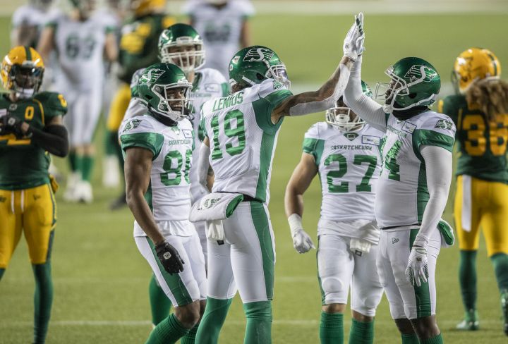 Saskatchewan Roughriders' Brayden Lenius (19), D'haquille Williams (14) high five as they celebrate their touchdown with Ricardo Louis (86) Brett Boyko (68) and Kienan LaFrance (27) while Edmonton Elks' Jonathan Rose (0) and Aaron Grymes (36) leave the field during first half CFL action in Edmonton on Friday, November 5, 2021. 