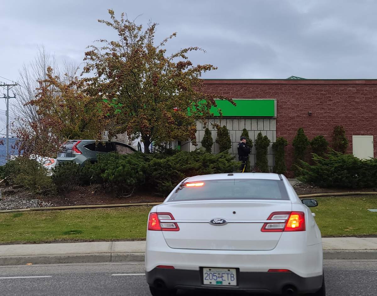 A screenshot of the green SUV parked beside a bank in Penticton.