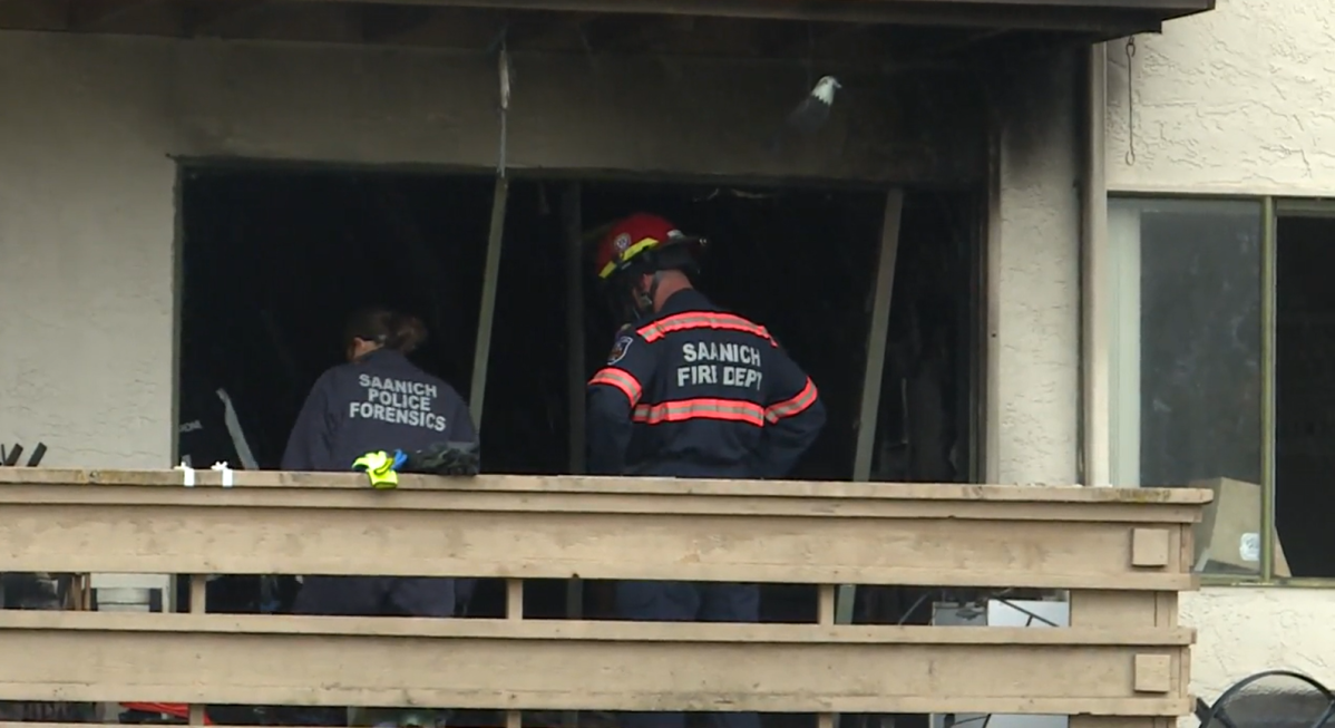 Members of the Saanich Fire Department and Saanich police forensics team attend the scene of a fatal apartment fire on Cook Street in Saanich, B.C., on Mon. Nov. 1, 2021. The fire broke out around 9:30 p.m. on Oct. 31, 2021.
