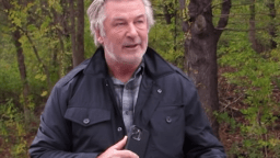 Alec Baldwin answers questions from paparazzi on the side of the road in Vermont.