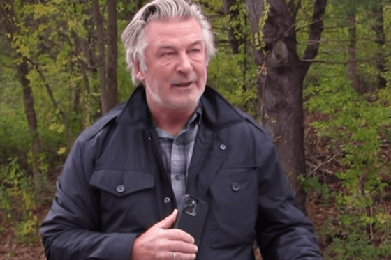 Alec Baldwin answers questions from paparazzi on the side of the road in Vermont.