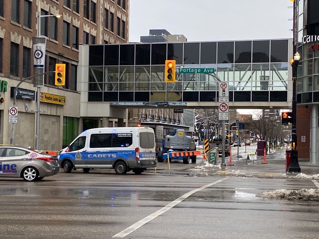 A skywalk over Donald Street near Portage Avenue and the sidewalks under it are closed after the walkway was hit by snow clearing equipment.