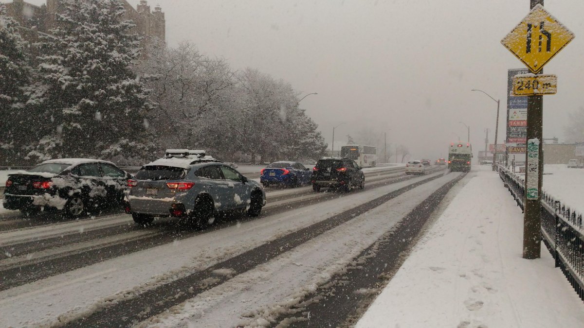 Cars seen driving along a snowy street in this file photo.