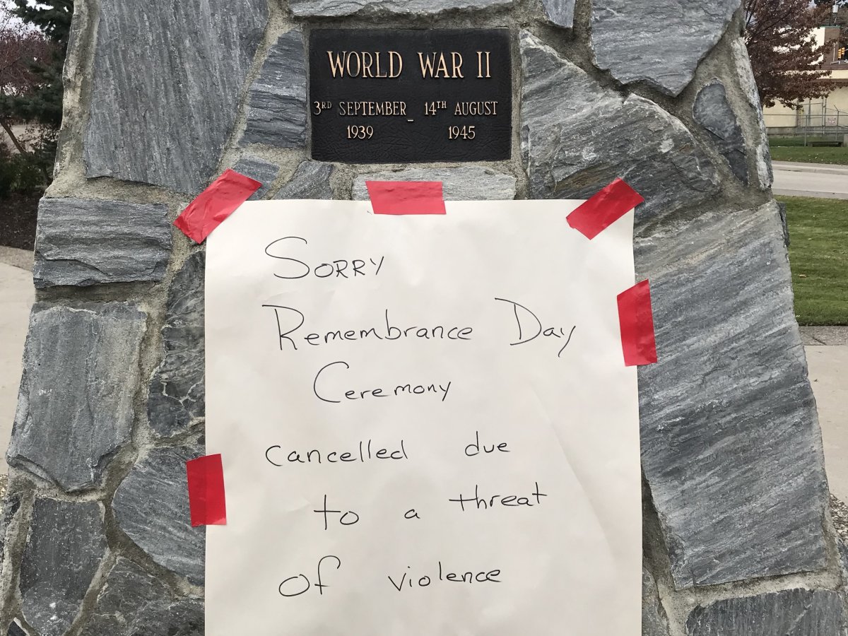 A sign at the Winfield cenotaph, stating the Remembrance Day ceremony had been cancelled because of a threat of violence. 