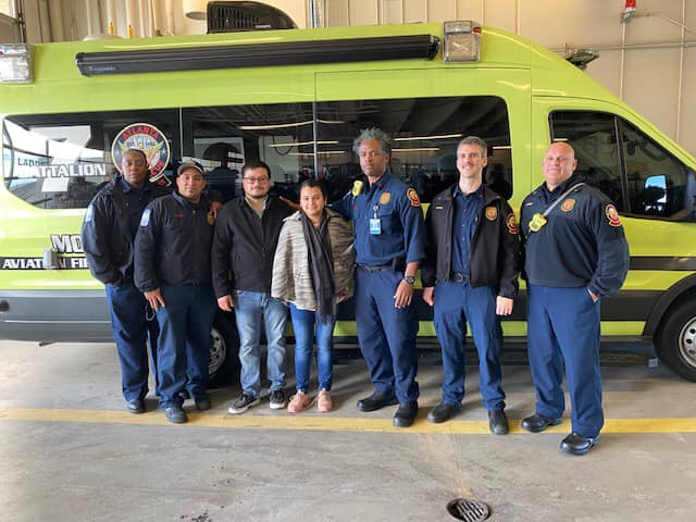 Liliana Castañeda Avilia poses with members of the Atlanta Fire Rescue Department, who helped deliver her little girl.