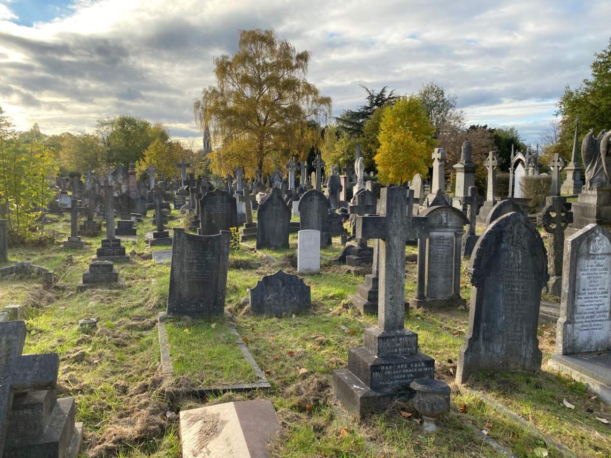 The small white Royal Air Force gravestone of Lt. James Gordon Moore in Hampstead Cemetery, London, England.