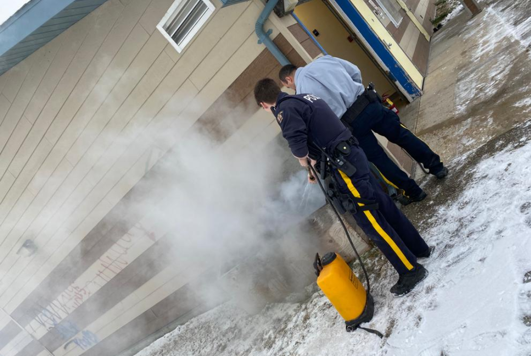 Chemawawin RCMP extinguish a garbage fire at their detachment.