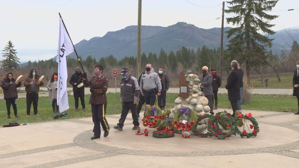 Gloria Morgan leads a closing procession at the end of the Splatsin Remembrance Day ceremony.