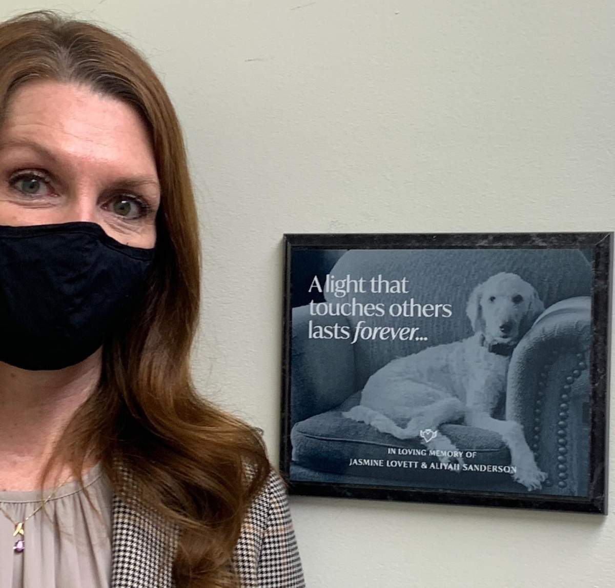 Kim Blankert, Jasmine Lovett’s mom and Aliyah Sanderson’s grandma, stands near a plaque honouring the pair at the Calgary Women’s Emergency Shelter.