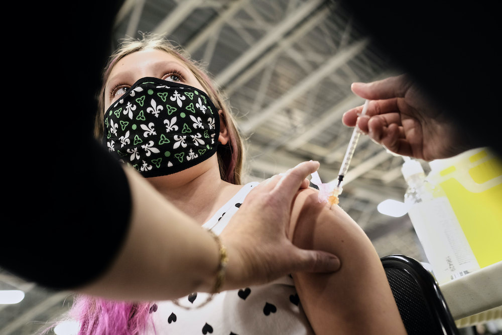 Julie Vernooy, age 10, gets her COVID-19 vaccine inside the COVID-19 vaccination clinic at the Nepean Sportsplex in Ottawa Friday, November 26, 2021. Kids as young as four have mistakenly been able to book COVID-19 vaccinations via the provincial portal, OPH said Tuesday.