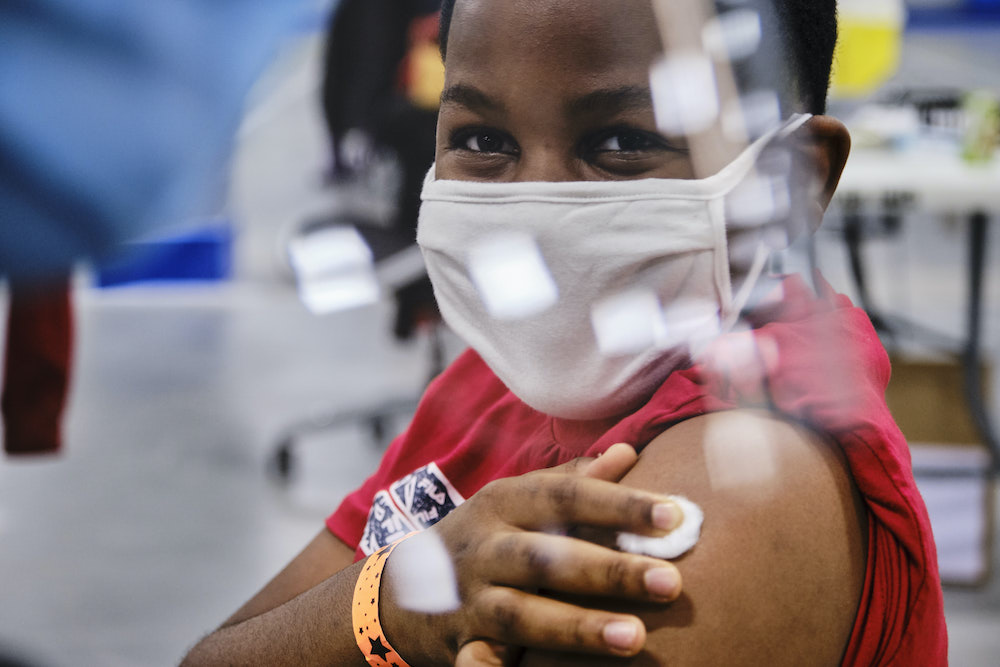 Ikenna Iheonunekwu receives the COVID-19 vaccine for kids inside the COVID-19 vaccination clinic at the Nepean Sportsplex in Ottawa Friday, November 26, 2021. 