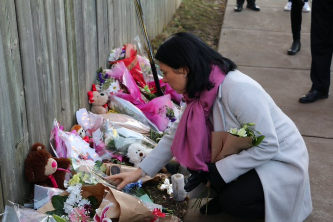 Montreal Mayor Valérie Plante leaves flowers at a makeshift memorial where a 16-year-old was shot and killed on Sunday. 