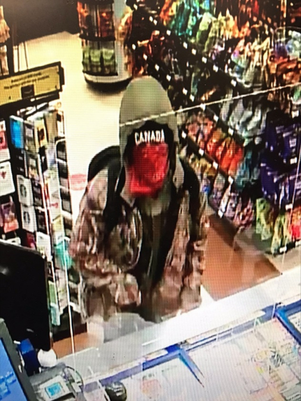 Peterborough police say a man with a rifle robbed a convenience store on Saturday morning.