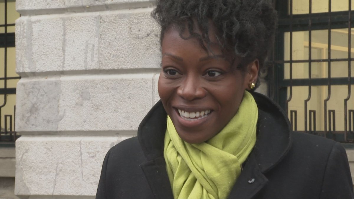 Martine Musau Muele meets with the press outside Montreal city hall on Thursday Nov. 25, 2021.