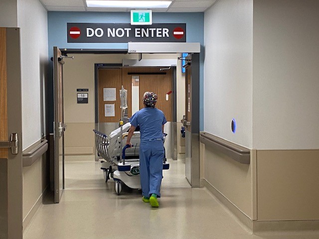 A patient is wheeled into an operating room.