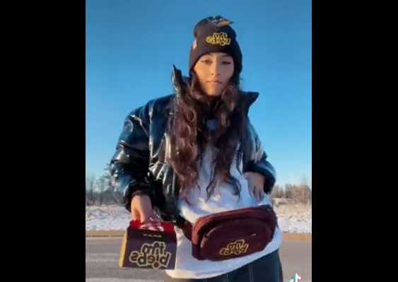 a girl poses in her TimBiebs swag