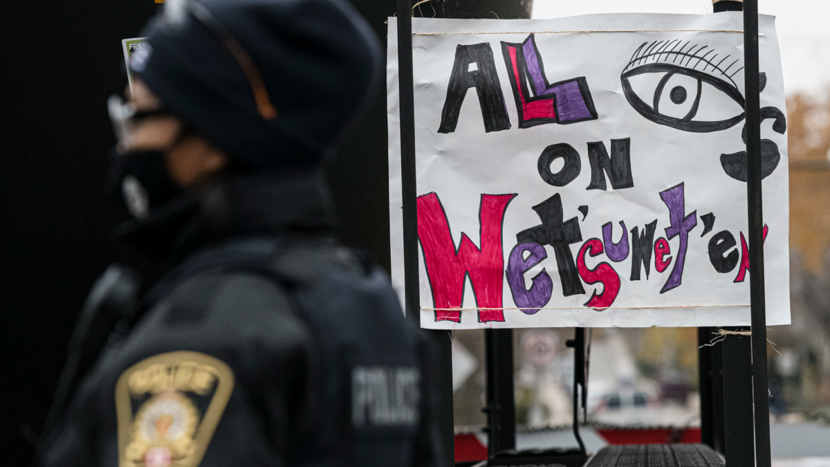 Police guard a train after protesters blocked a rail line in support of Wet'suwet'en land defenders who were arrested by the RCMP on Friday in northern British Columbia, in Toronto, on Sunday, Nov. 21, 2021. 
