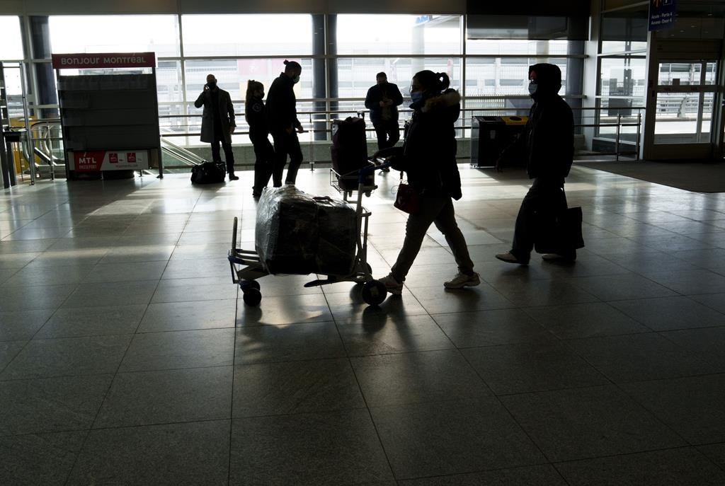 Passengers make their way through Montreal-Trudeau airport in Montreal, on Wednesday, December 1, 2021. 