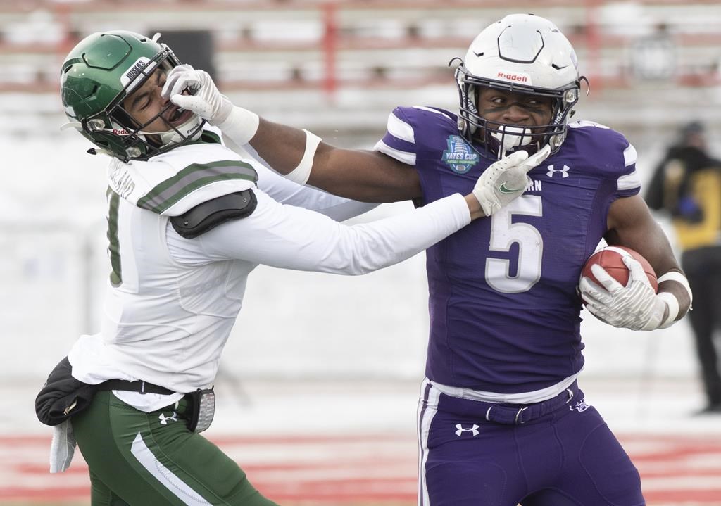The Western University Mustangs' Keon Edwards pushes Saskatchewan University Huskies defensive back Charlie Ringland during second-quarter action at the Vanier Cup in Quebec City, Saturday, Dec. 4, 2021.