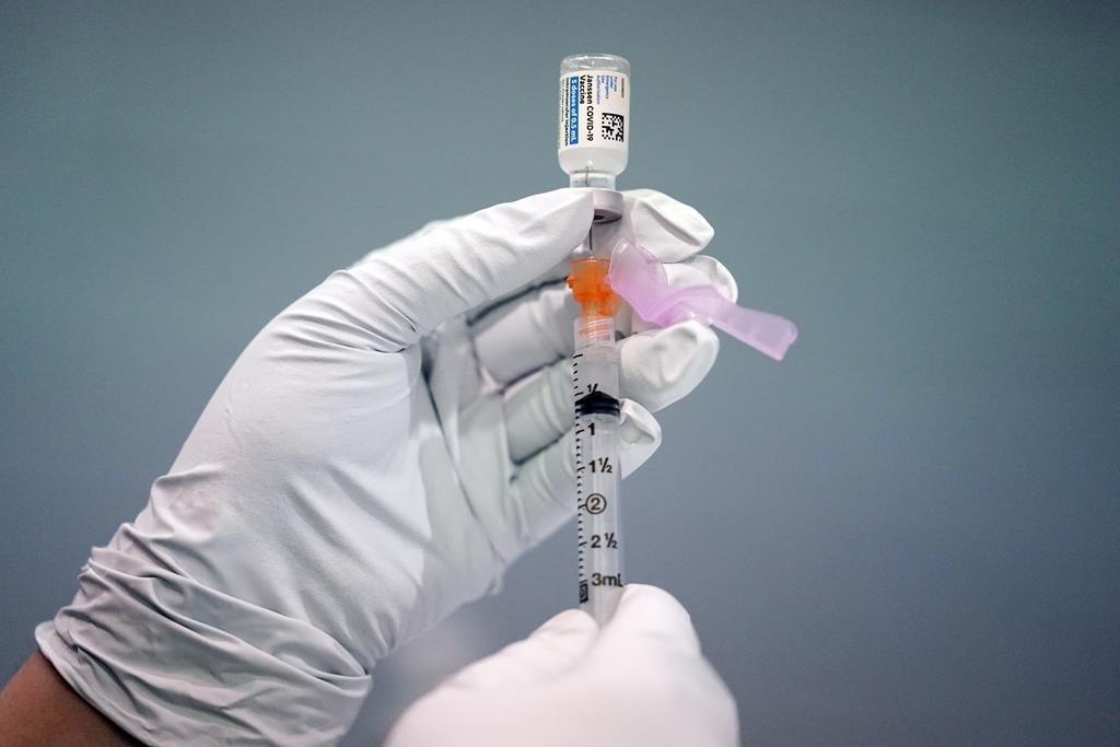 FILE - A member of the Philadelphia Fire Department prepares a dose of the Johnson & Johnson COVID-19 vaccine at a vaccination site setup in Philadelphia, on March 26, 2021.