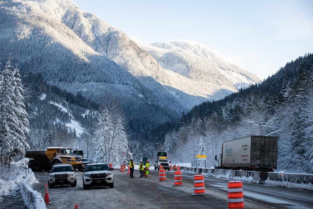A transport truck travels on the Coquihalla Highway after it was reopened to commercial traffic northeast of Hope, B.C., on Dec. 20, 2021. British Columbia is again extending its provincial state of emergency that's been in place since Nov. 17.
